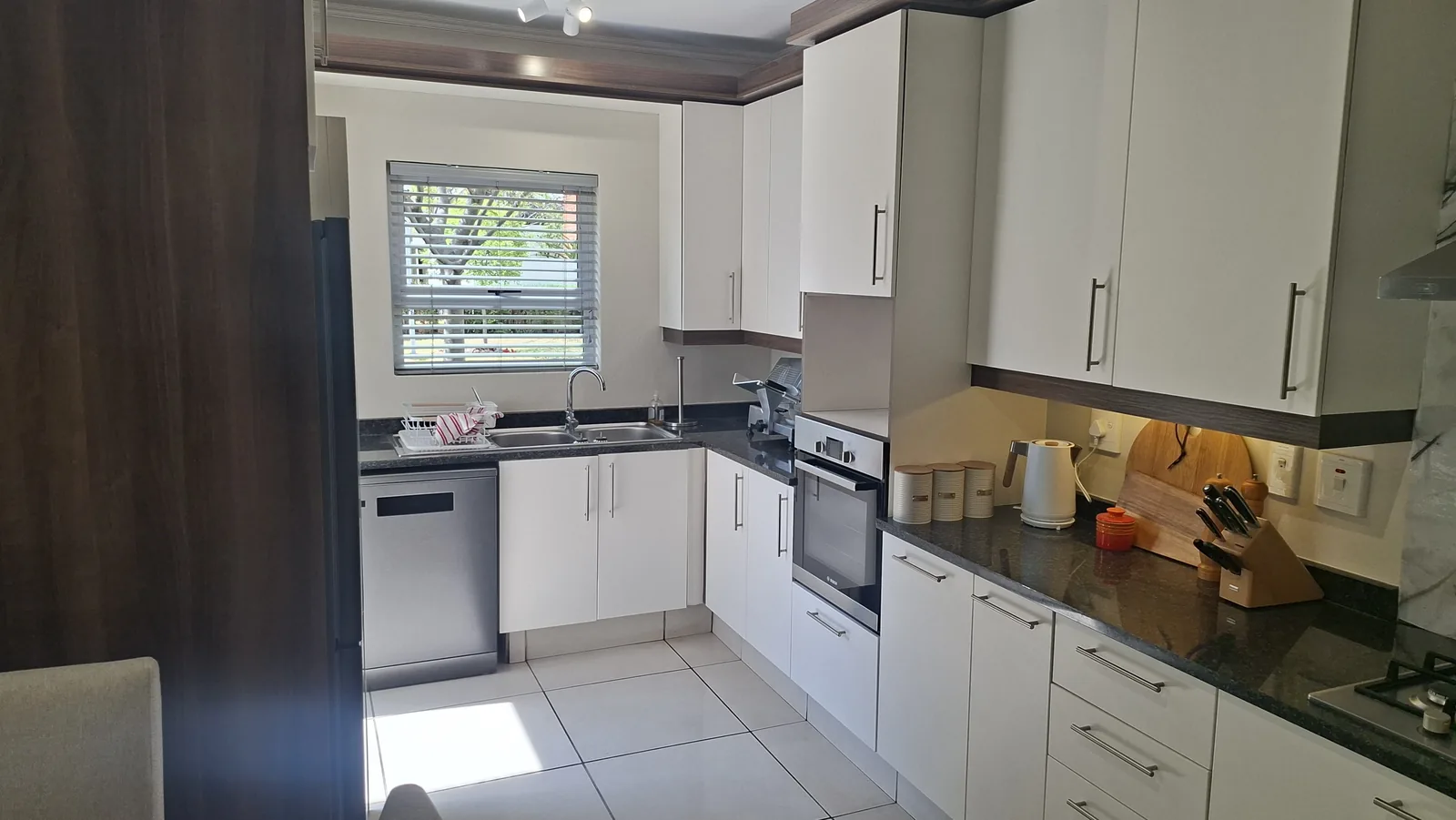 Kitchen after wrapping, cupboard doors refinished in matt cream film, Durban